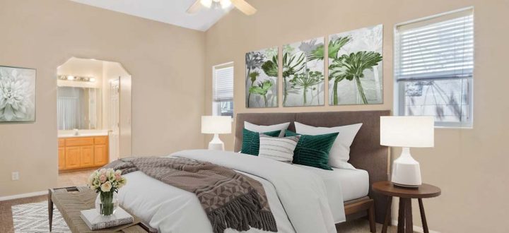 A serene and spacious bedroom with a large window, modern decor, and a plush bed, creating a restful environment with abundant natural light.