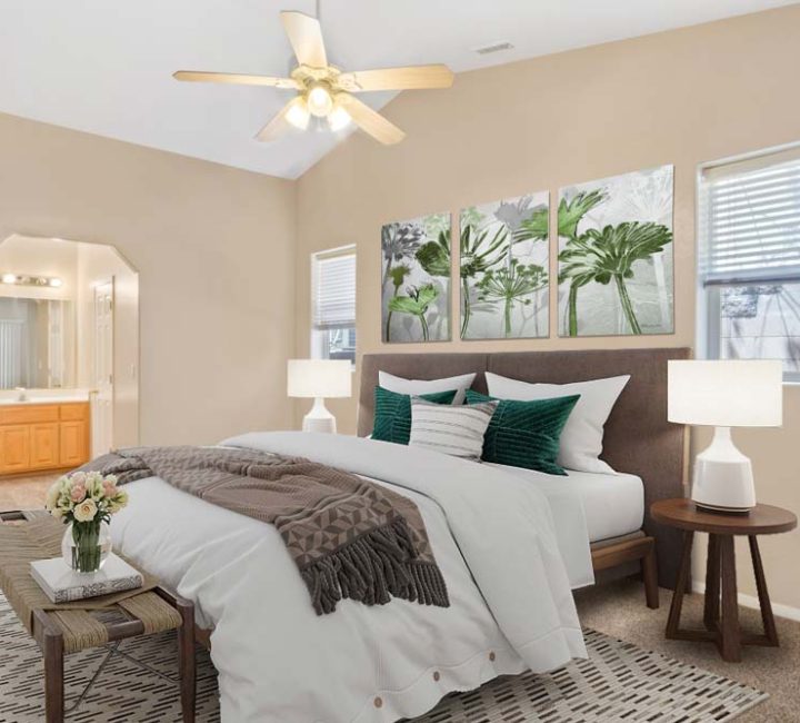 A serene and spacious bedroom with a large window, modern decor, and a plush bed, creating a restful environment with abundant natural light.